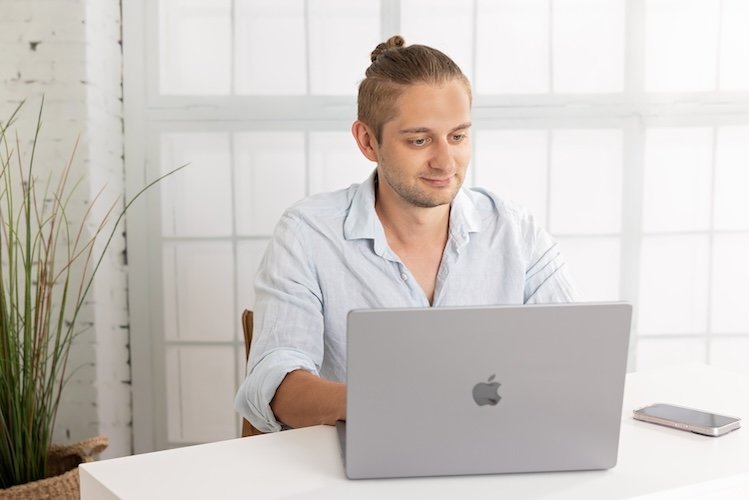 Patrick Schratz working at his desk with multiple monitors